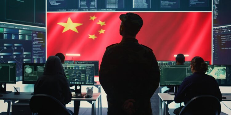 Communist China military personnel in a high tech government hacking room work on stealing state secrets from rival countries in hybrid war. Chinese communist criminals and army exploit advanced technology, inflict fear. Camera B.