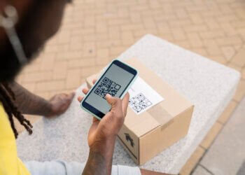 hand of parcel delivery man, with qr code