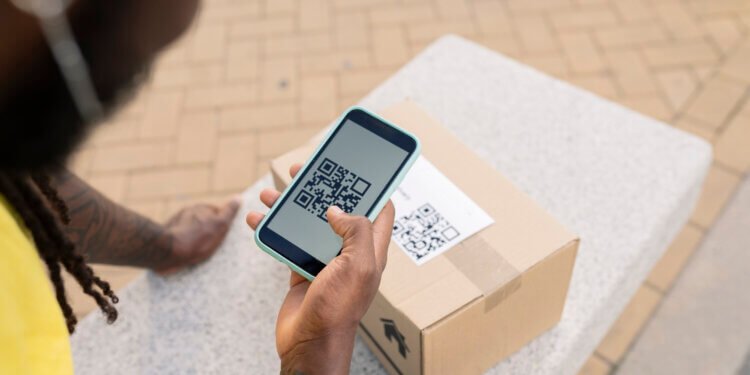 hand of parcel delivery man, with qr code