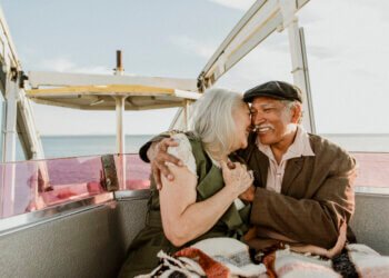Cheerful senior couple enjoying a Ferris wheel by the Santa Monica pier