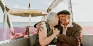 Cheerful senior couple enjoying a Ferris wheel by the Santa Monica pier
