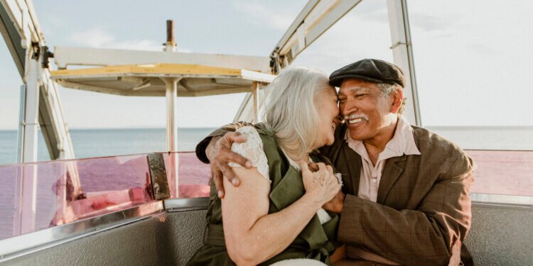 Cheerful senior couple enjoying a Ferris wheel by the Santa Monica pier