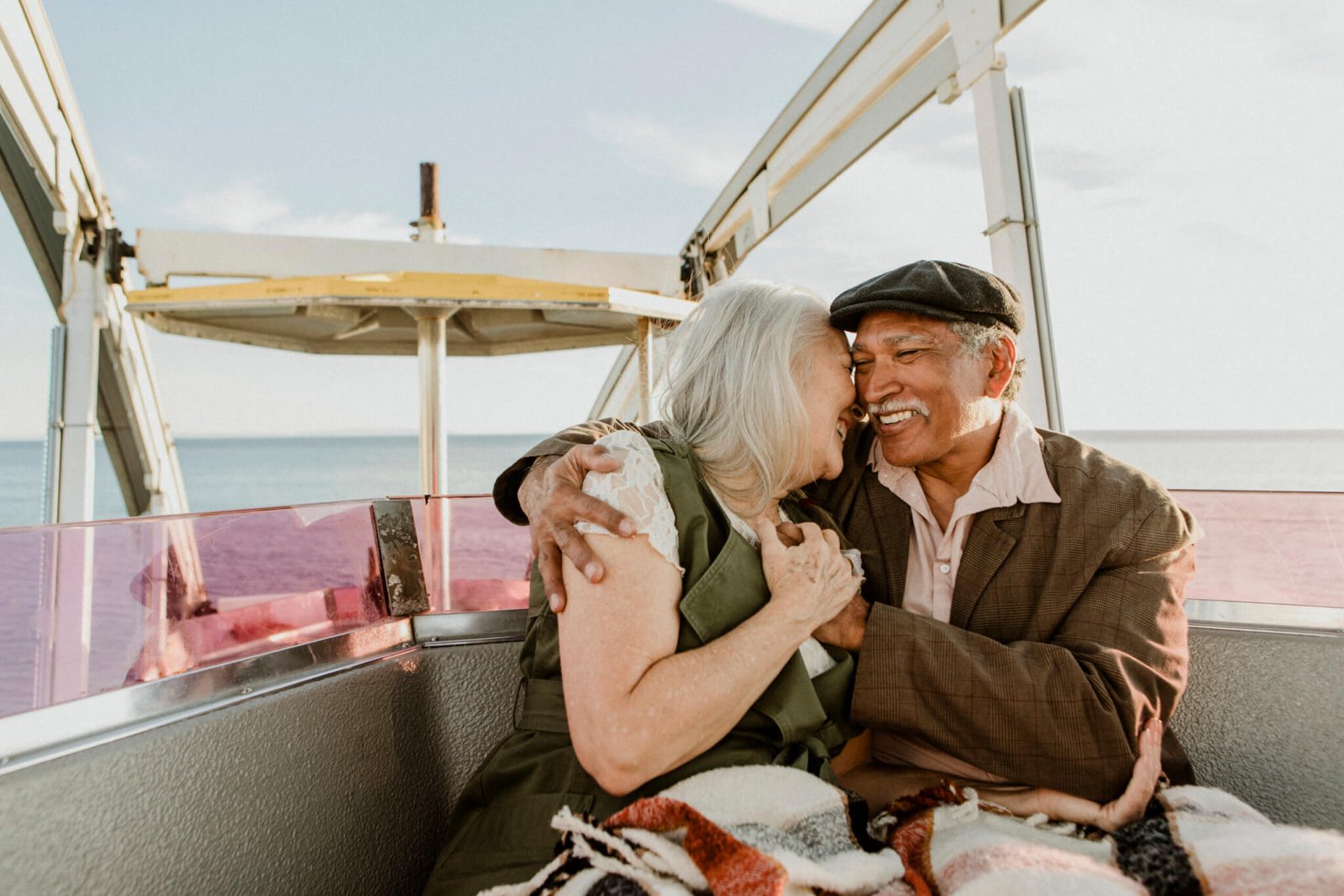 Cheerful senior couple enjoying a Ferris wheel by the Santa Monica pier