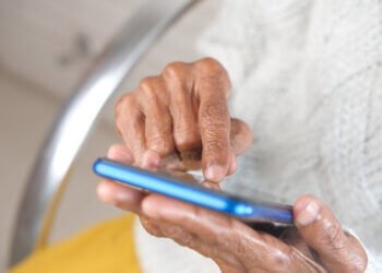 senior women hand using smart phone close up