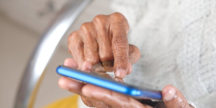 senior women hand using smart phone close up