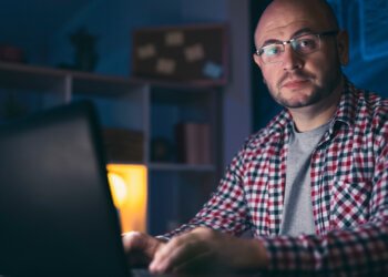 Male web designer working late at night