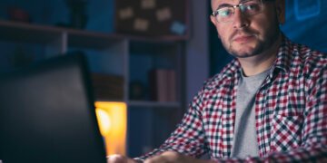 Male web designer working late at night